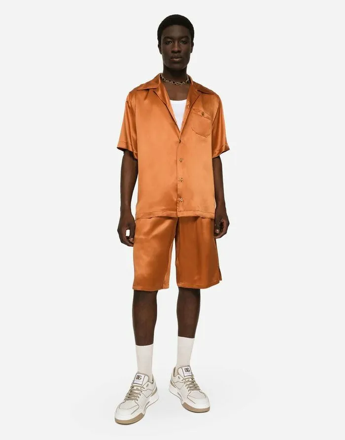 Dolce and Gabbana Trousers And Shorts Men Silk Satin Jogging Shorts With Metal DG Logo Beige Dolce and Gabbana Trousers And Shorts Men Silk Satin Jogging Shorts With Metal DG Logo Beige